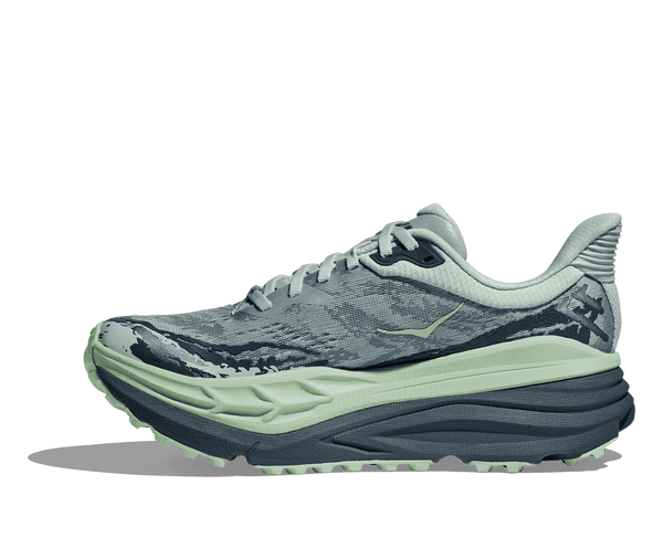 A green Hoka logo can be found near the ankle on the medial side of the upper. 