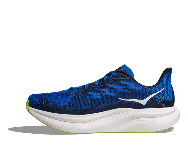 The medial side of the shoe has navy blue accents on the upper. 