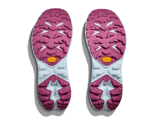 Pink and white shoe sole with brand logo on a green background