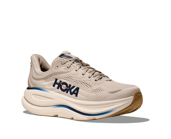 Beige running shoe with 'Hoka' branding on a transparent background