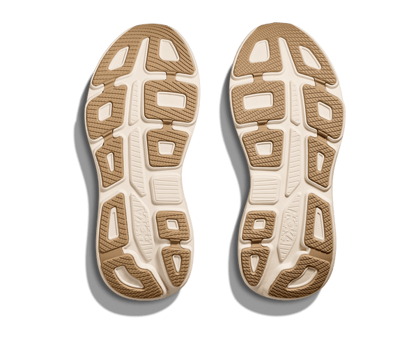 Close-up of a pair of brown and white shoe soles on a transparent background