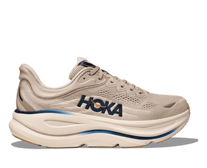 Beige running shoe with Hoka branding on a transparent background