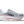 Gray running shoe with white sole and red accents on a transparent background