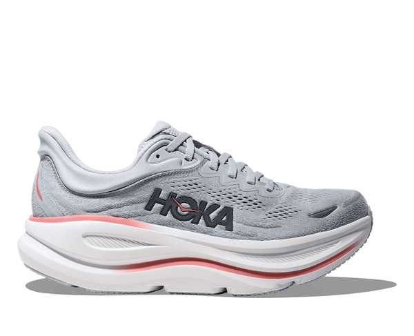Gray running shoe with white sole and red accents on a transparent background