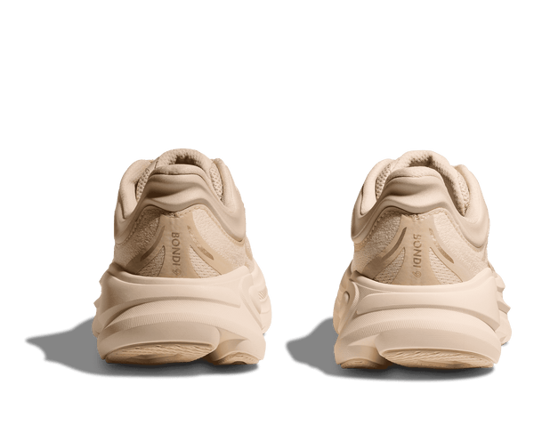 Pair of beige sneakers on a transparent background.