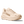 Beige running shoe with 'Hoka' branding on a transparent background.