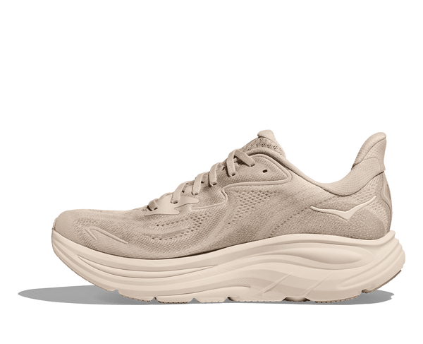The Hoka logo is stitched near the ankle on the medial side of the upper in cream thread.