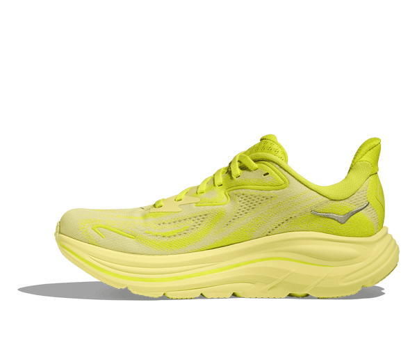 The Hoka logo is stitched near the ankle on the medial side of the upper in silver thread. 