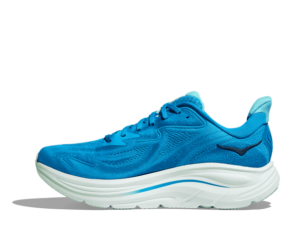 The Hoka logo is stitched near the ankle on the medial side of the upper in navy thread. 