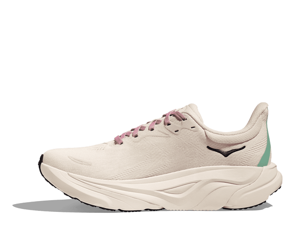 The Hoka logo is stitched near the ankle on the medial side of the upper. 