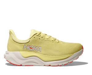 Yellow Hoka Arahi 8 running shoe with white sole on a transparent background