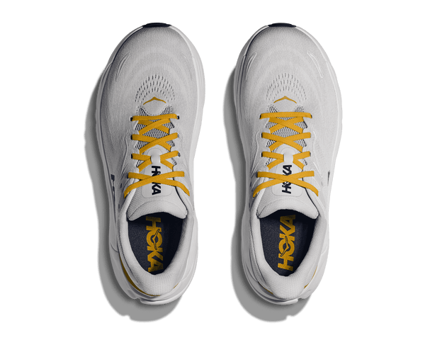 A birds-eye view of this shoes a navy blue insole and yellow Hoka logo printed at the bottom of the laces on the upper. 