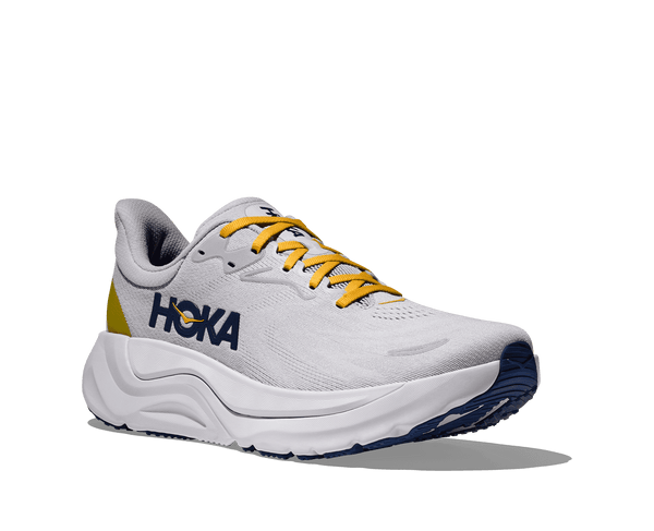 This shoe has mustard yellow laces to contrast the grey upper. 