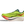 Green running shoe with red accents on a transparent background