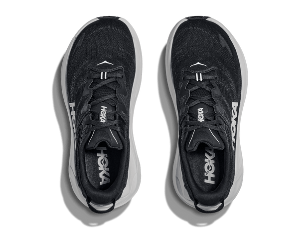Black running shoes with white soles on a transparent background