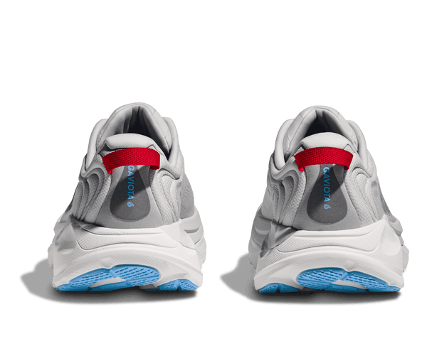 Gray sneakers with red interior and blue sole on a transparent background
