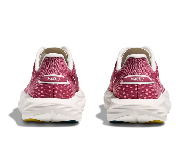 Pair of pink running shoes with 'MACH 7' label on a white background