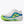 A white running shoe with a thick white midsole, featuring a vibrant lime green and blue gradient side accent with a black logo, and a bright lime green outsole.