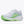 White running shoe with green sole on a white background