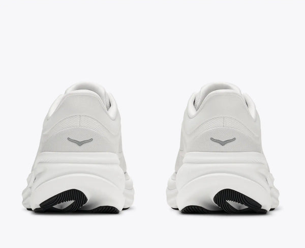 A pair of white athletic sneakers shown from the back, featuring a white leather upper, chunky white sole, and a black textured outsole.