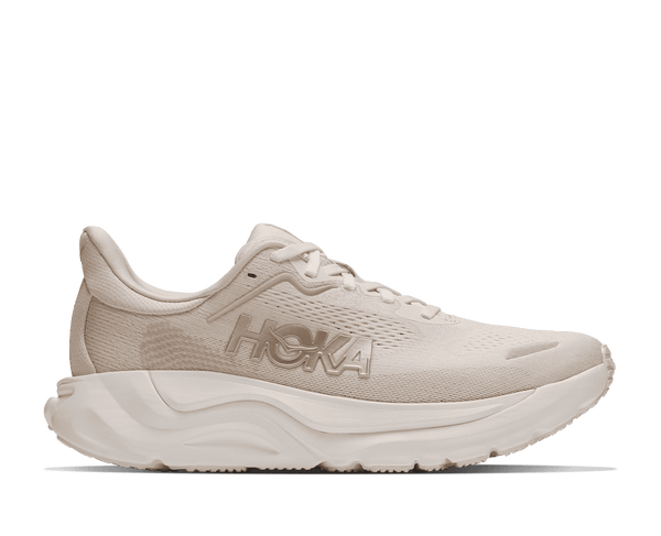 Cream colored running shoe on a white background