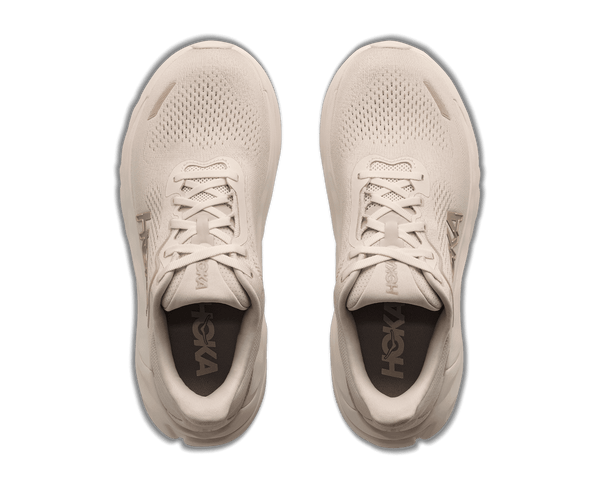 Cream colored running shoe on a white background