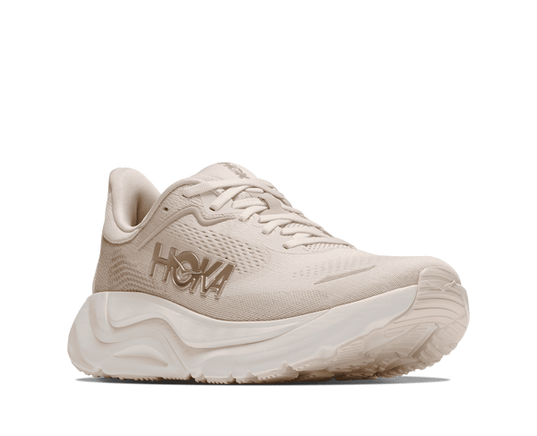 Cream colored running shoe on a white background