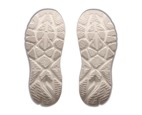 Cream colored running shoe on a white background