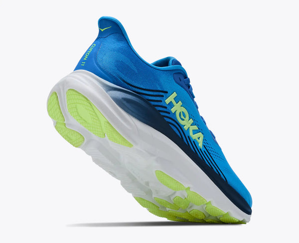Blue running shoe with green sole on a white background