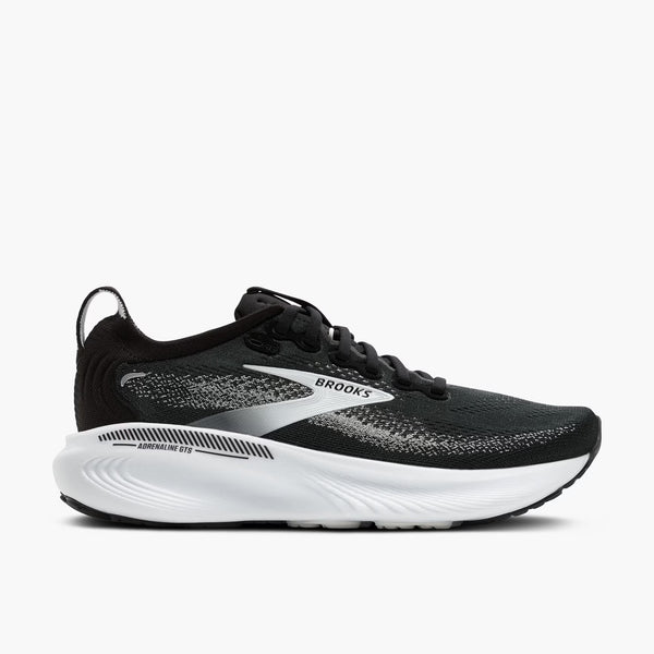 Black running shoe with white sole on a light gray background