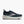 Navy running shoe with white sole on a light gray background