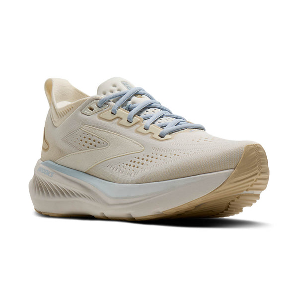 Beige running shoe with a white sole on a white background
