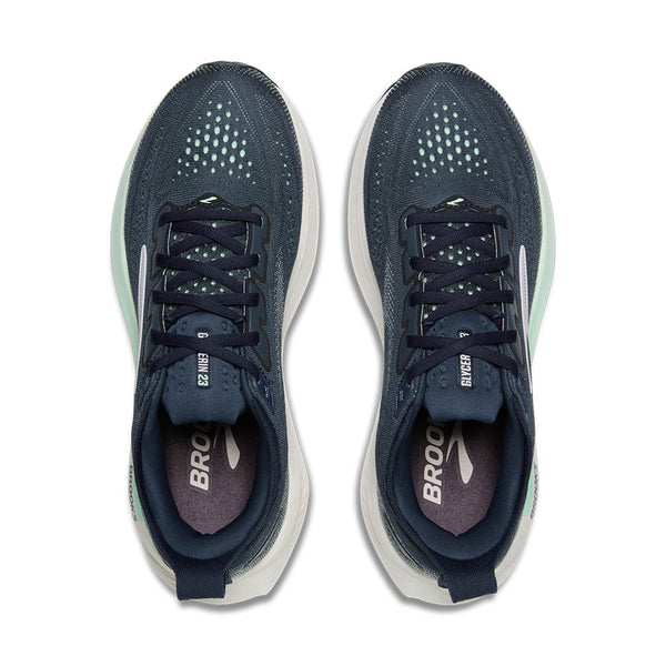 Pair of navy running shoes with white soles on a white background
