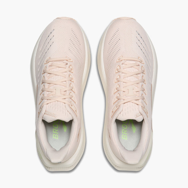 A pair of light beige athletic sneakers shown from a top-down view on a clean white background. The shoes feature a breathable mesh upper, matching laces, and a thick cushioned sole, with a bright green 'BROOK' logo printed on the insole.