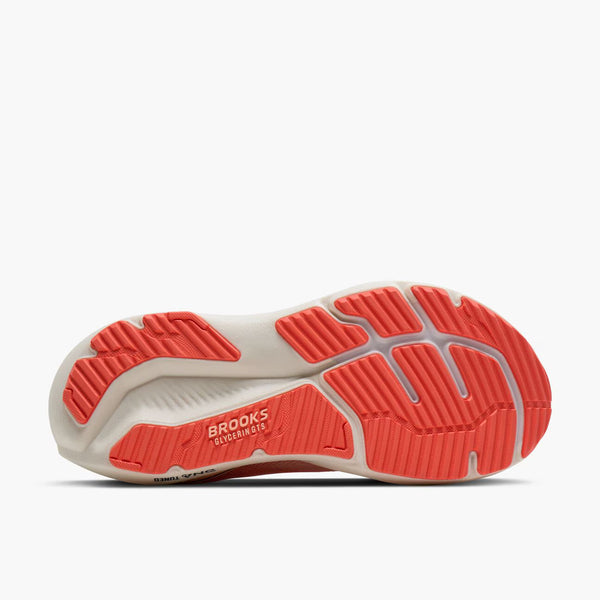 Sole of a running shoe with red tread pattern on a white background