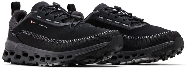 Black athletic shoes inpired casual shoes with visible brand logo on a white background.