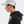 Person wearing a white cap and black hoodie on a light gray background