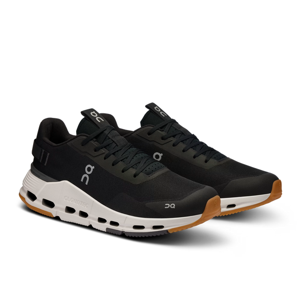 Black running shoe with white sole on a white background