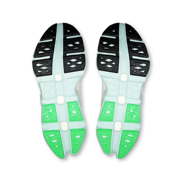 The outrsole of this Women's on Cloudmonster hyper is partly black, green and white.