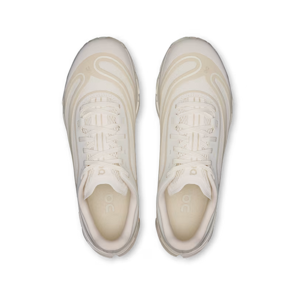 A pair of low-top athletic sneakers shown from a top-down view on a clean white background. The shoes are predominantly off-white/cream with subtle warm beige accents and tonal detailing.