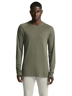 Man wearing a green long-sleeve shirt on a white background