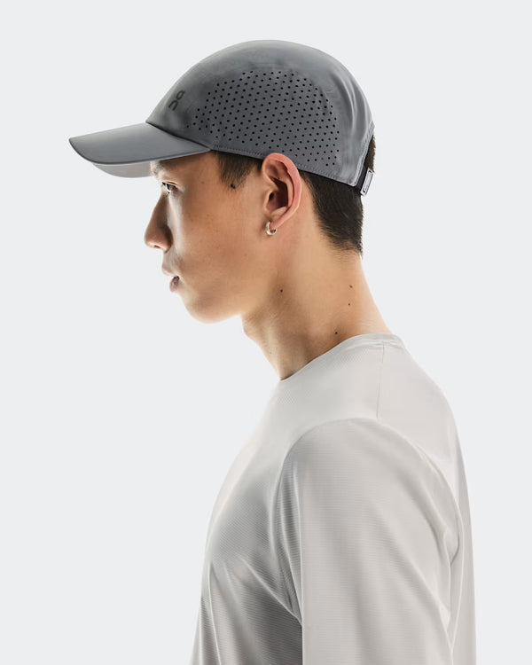 Person wearing a gray cap and light gray shirt on a white background