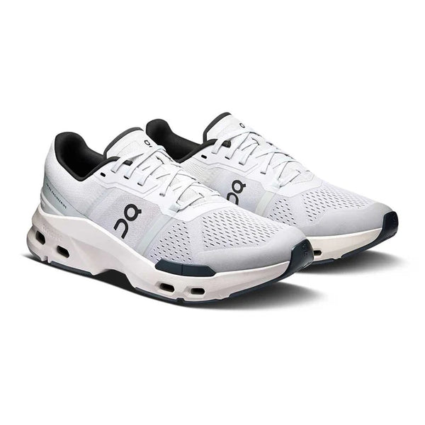 A pair of white work out shoes with black accents on a white background.
