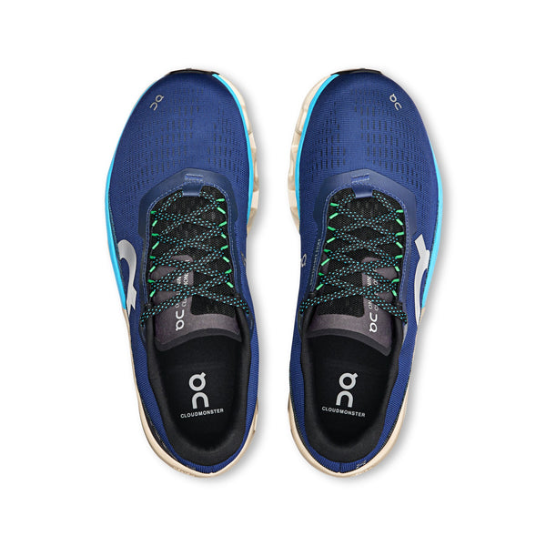 A pair of men's On Cloudmonster 2 blue running shoes with visible branding on a white background.
