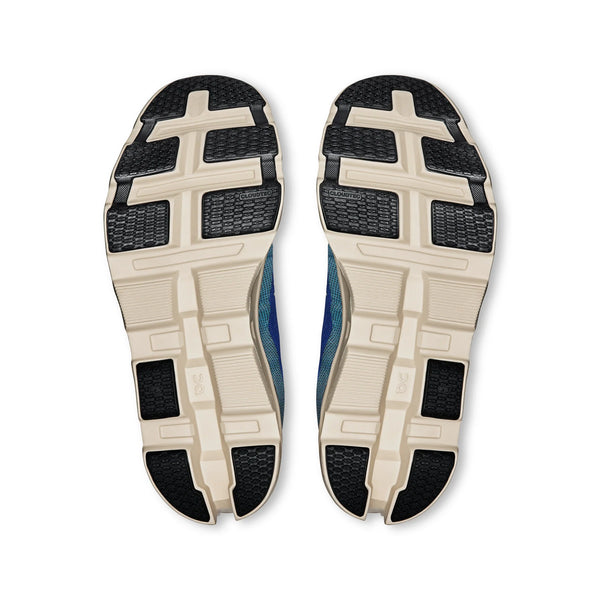 Close-up of the outsole of an On men's Cloudmonster 2 running shoes with a white background