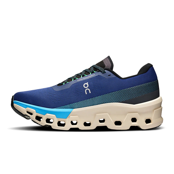 The medial side of a blue running shoe with a white midsole on a white background.