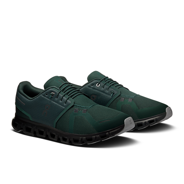 Pair of green athletic shoes on a white background