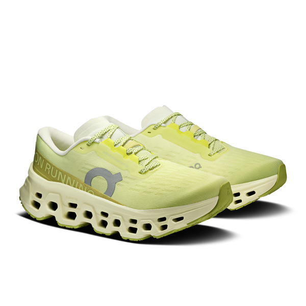 Pair of light green running shoes with 'On' branding on a white background