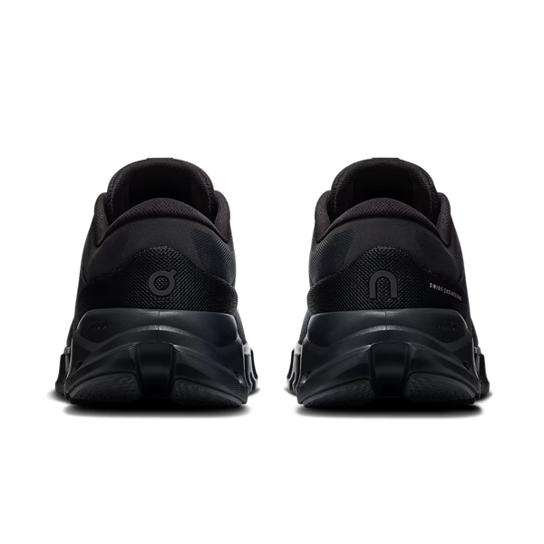 A pair of black athletic sneakers shown from the rear, featuring chunky black soles and textured mesh uppers, set against a plain white background.