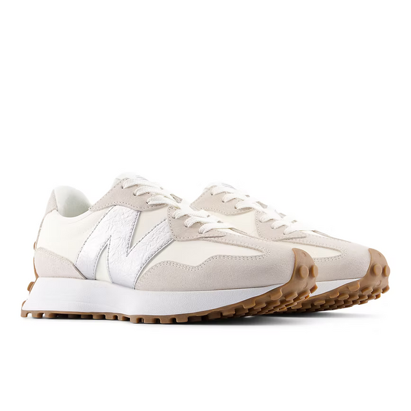 Pair of beige and white sneakers on a white background